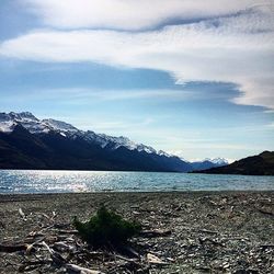 Scenic view of lake and mountains against sky