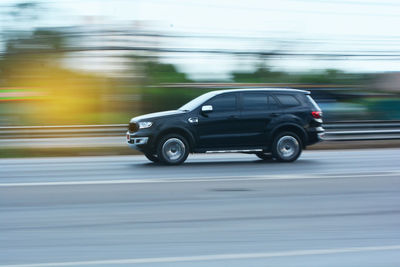 Side view of car moving on road