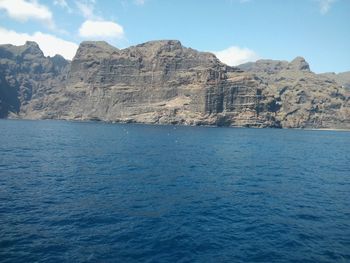 Scenic view of rock formation in sea against sky