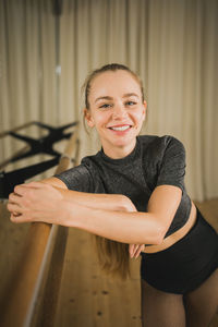 Portrait of young woman sitting at home