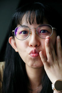 Close-up of young woman puckering lips