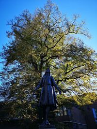 Low angle view of statue against trees