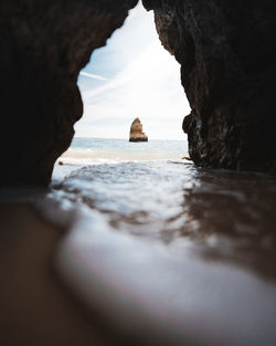 Scenic view of sea seen through cave