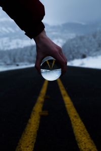 Close-up of person holding crystal ball