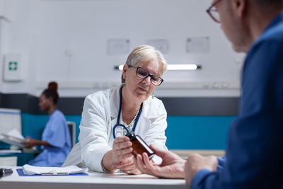 Female doctor prescribing medicine