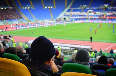 Rear view of people looking at stadium