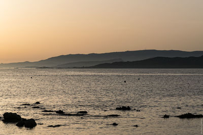 Scenic view of sea against clear sky during sunset