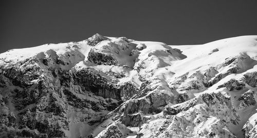 Scenic view of snowcapped mountains against clear sky