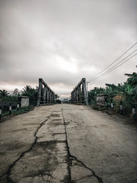 Surface level of empty bridge against sky