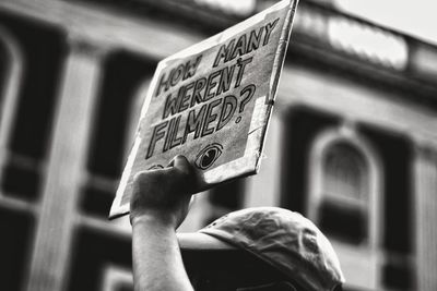 Low-view angle of person holding protest sign