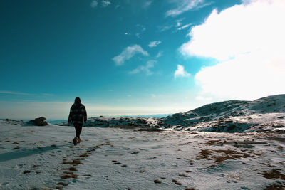 Rear view of man on snow covered land