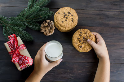 Cropped hands of person holding food on table