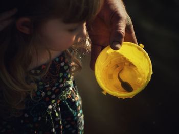 Man showing girl a tadpole