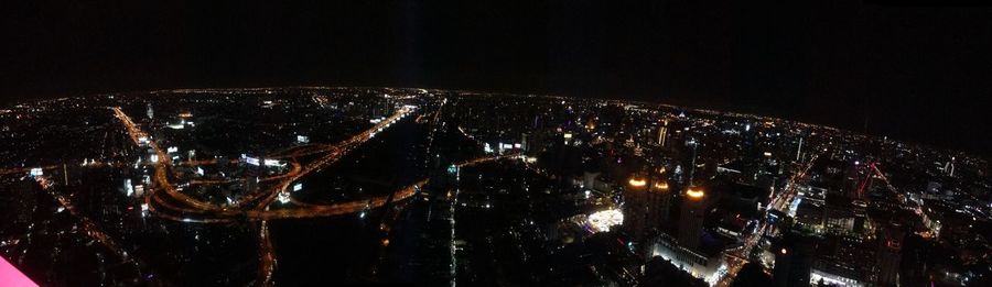 Aerial view of city lit up at night