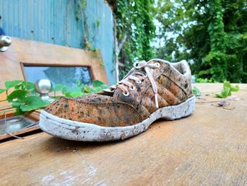 Close-up of shoes on wooden table