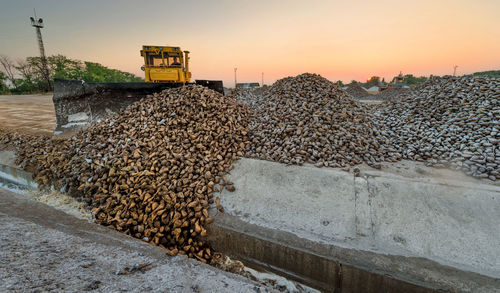 Construction vehicle at site during sunset