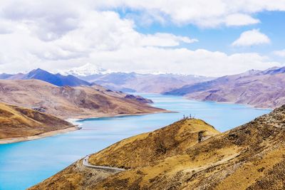 Scenic view of lake and mountains against sky