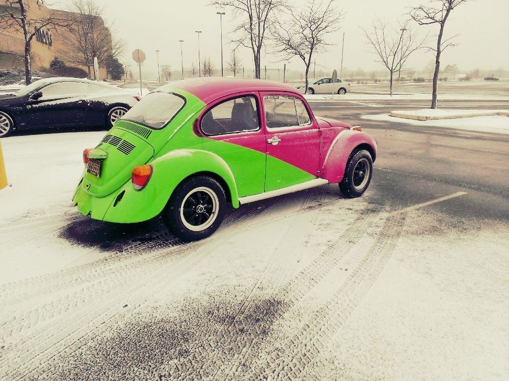 transportation, land vehicle, mode of transport, car, street, road, stationary, on the move, travel, day, outdoors, tree, snow, parking, bare tree, bicycle, road marking, winter, no people, side view