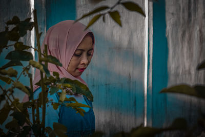 Side view of woman standing by plants