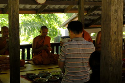 Rear view of couple sitting in corridor