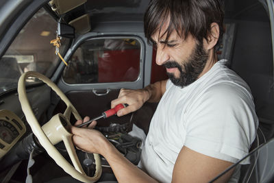 Man holding camera in car