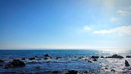 Scenic view of sea against blue sky