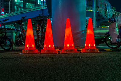 Illuminated red lights on road in city at night