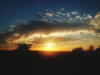 Scenic view of silhouette landscape against sunset sky