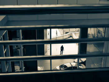 Man in city seen through window