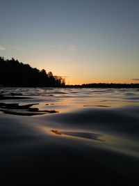 Scenic view of lake against sky at sunset