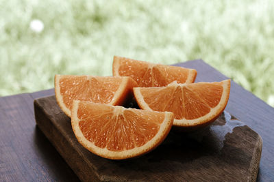 Close-up of orange slice on cutting board