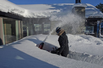 Man skiing on snowcapped mountain during winter