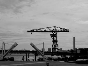 Cranes against sky in city