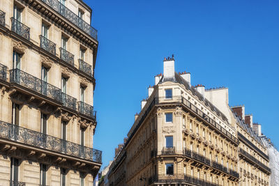 Paris traditional apartment complex with parisian style balconies and rooftop in paris, france