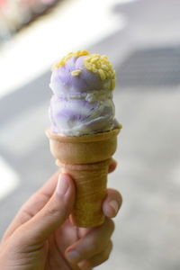 Cropped image of person holding ice cream cone