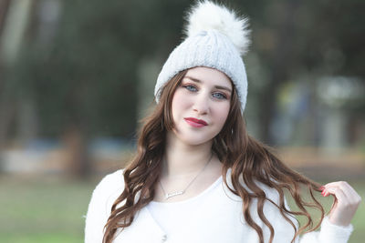 Portrait of young woman standing outdoors