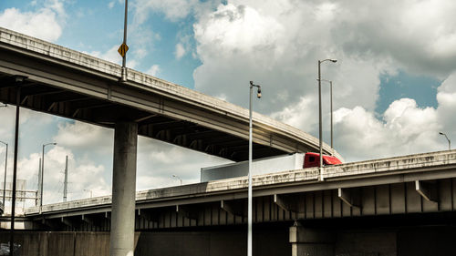 Low angle view of train on bridge against sky