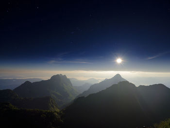 Scenic view of mountains against sky at night