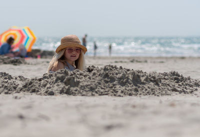 Girl buried at sandy beach