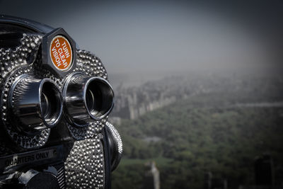 Close-up of coin-operated binoculars against sky