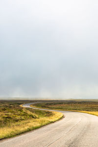 Single twisty, wavy, serpentine road with mist above, nc500, scotland