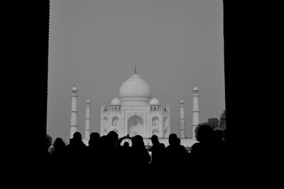 Silhouette people against clear sky