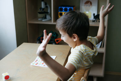 High angle view of girl playing with toy on table