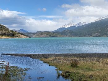 Scenic view of lake and mountains against sky