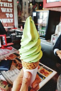 Close-up of hand holding ice cream cone