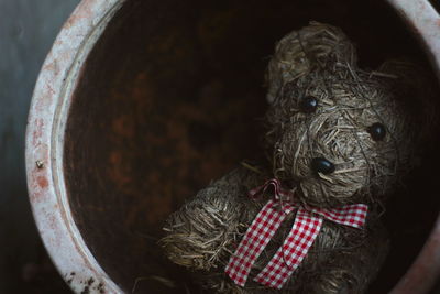 Close-up of abandoned teddy bear clay container