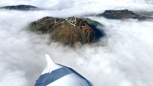 Aerial view of mountain amidst clouds