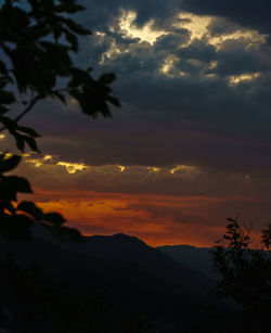 Scenic view of silhouette mountain against dramatic sky