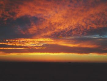 Scenic view of dramatic sky at sunset