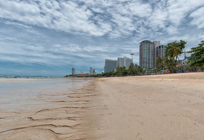 View of beach with city in background